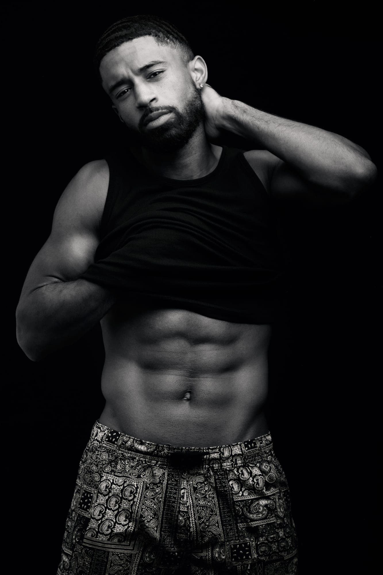 High-contrast black and white portrait of Abyon Ausar in a black tank top